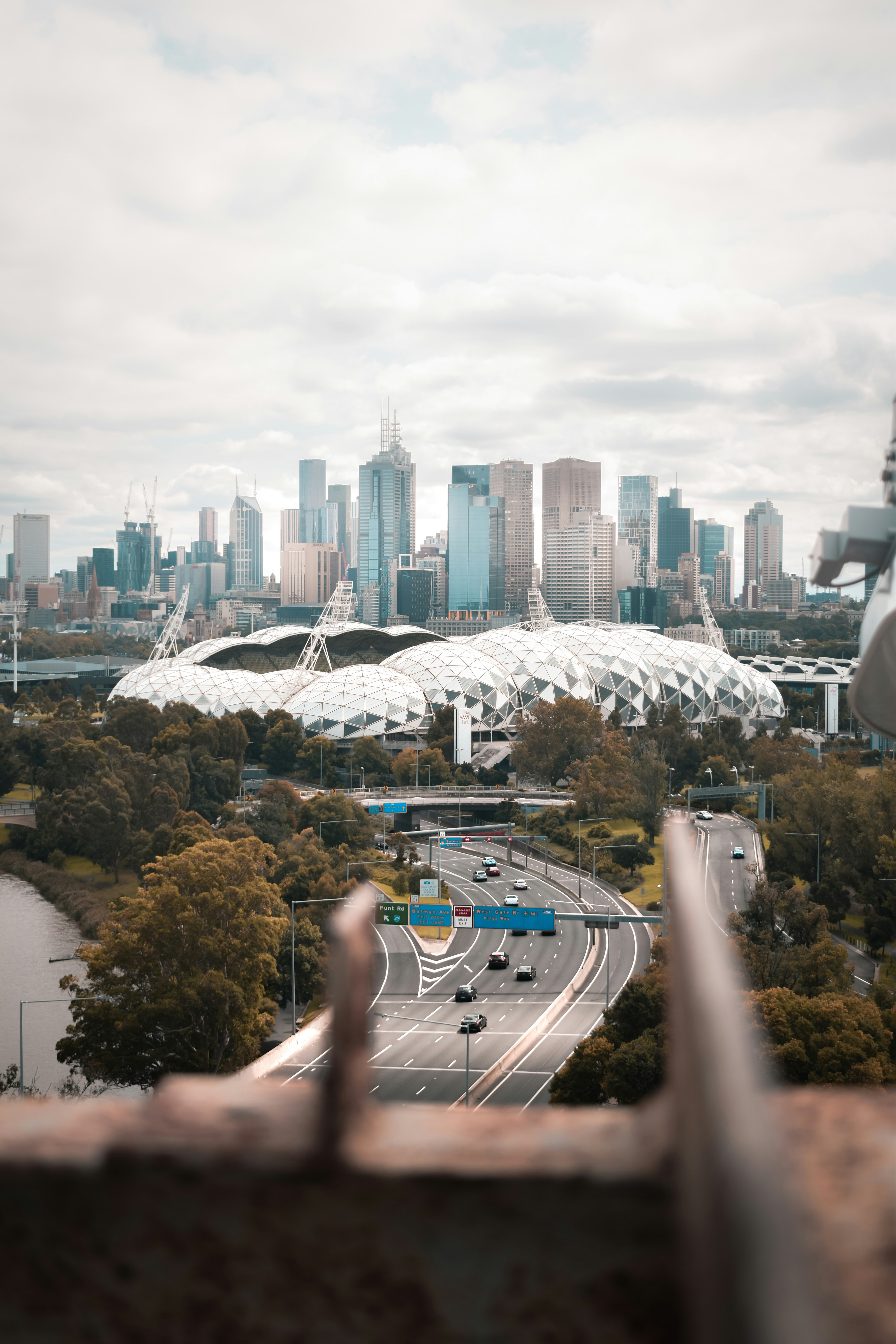 person holding smartphone taking photo of city buildings during daytime